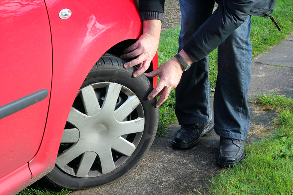 Owner checking over tyres Carshalton